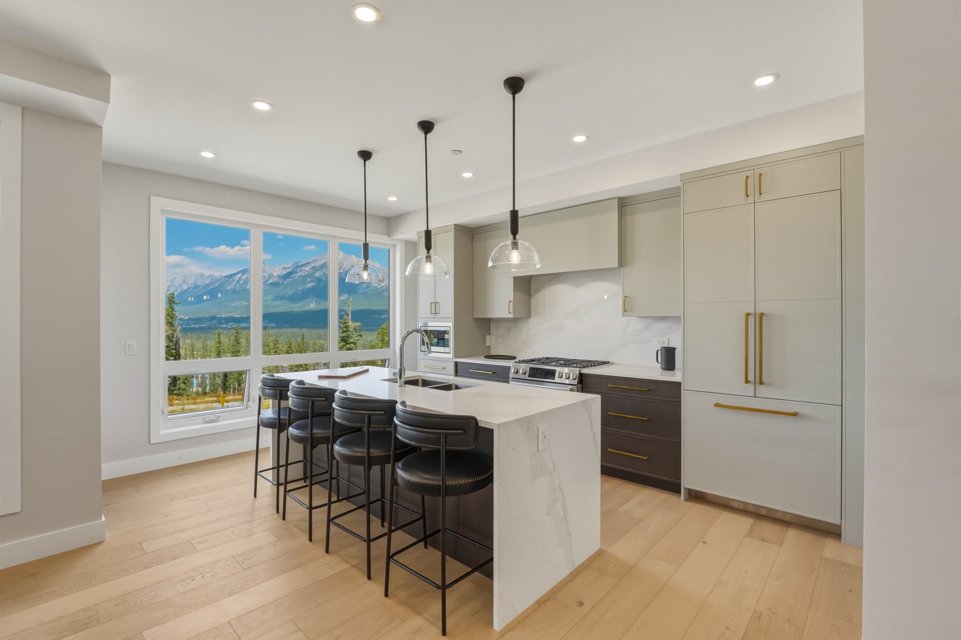 Chef's kitchen with quartz island and mountain view